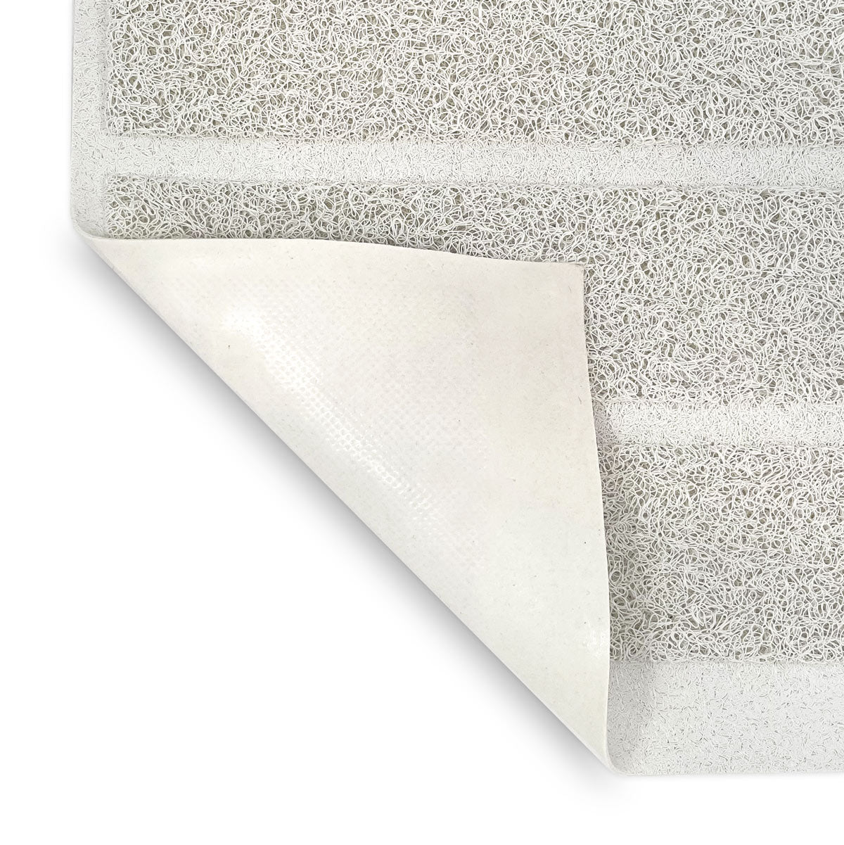 White litter mat detail with corner folded over showing the underside of the mat.