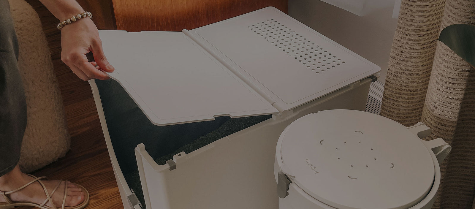 Cat owner lifting lid of Modkat Flip