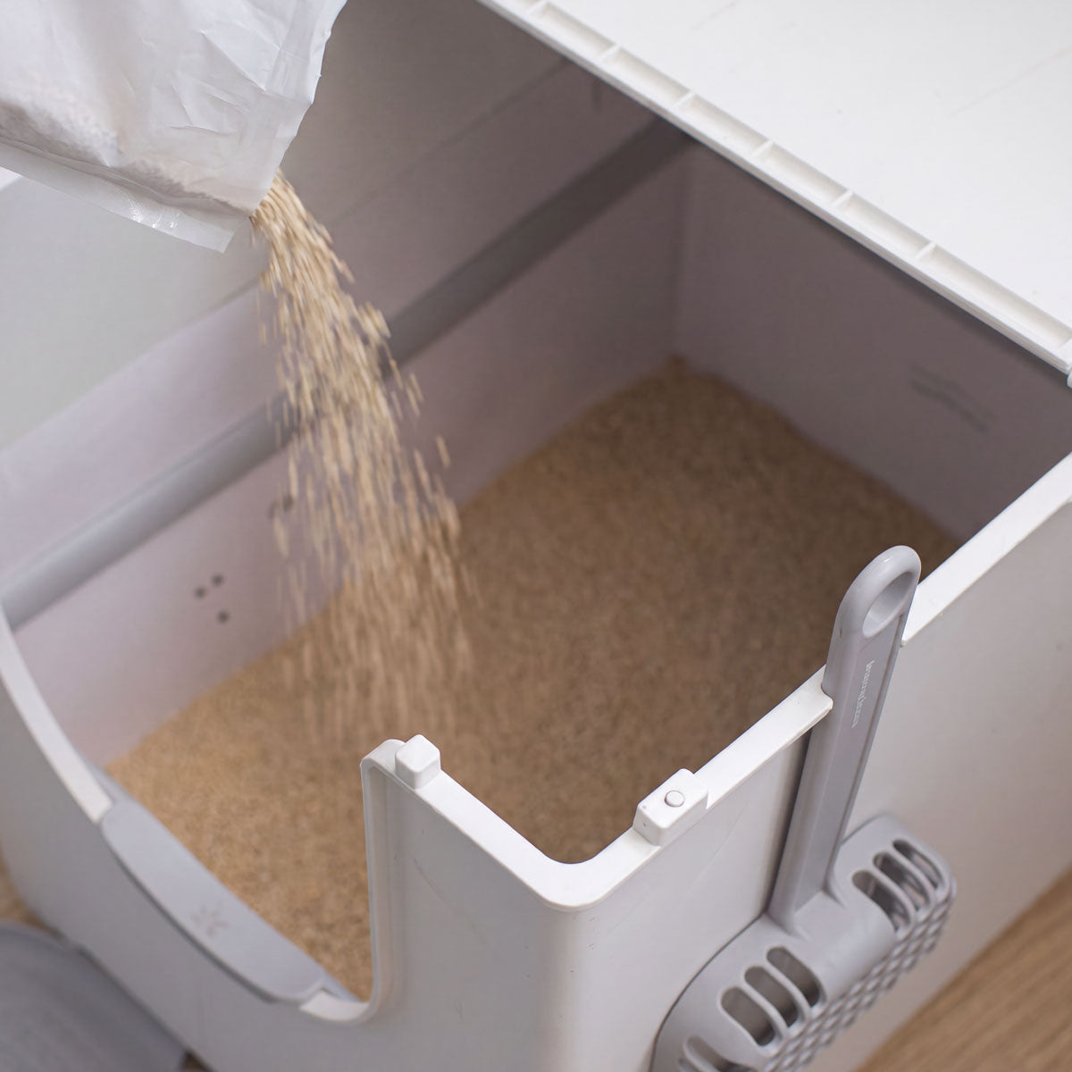 Litter pouring into the Flip litter box disposable liner